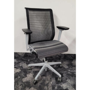 Steelcase Think mesh back task chair, silver swivel base oversized castors, silver frame, black mesh with black/white patterned seat.