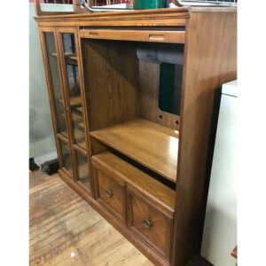 Wood entertainment centre with roll down door. lots of storage