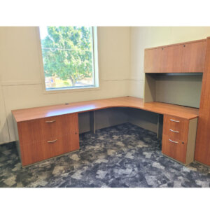 L-shape Desk with Hutch Overall: 83"w x 107"d Cherry surface with grey base 1" thick laminate One locking box/box/file pedestals Grommet holes 48"w hutch with doors (24.5" monitor clearance) Tack board Task light